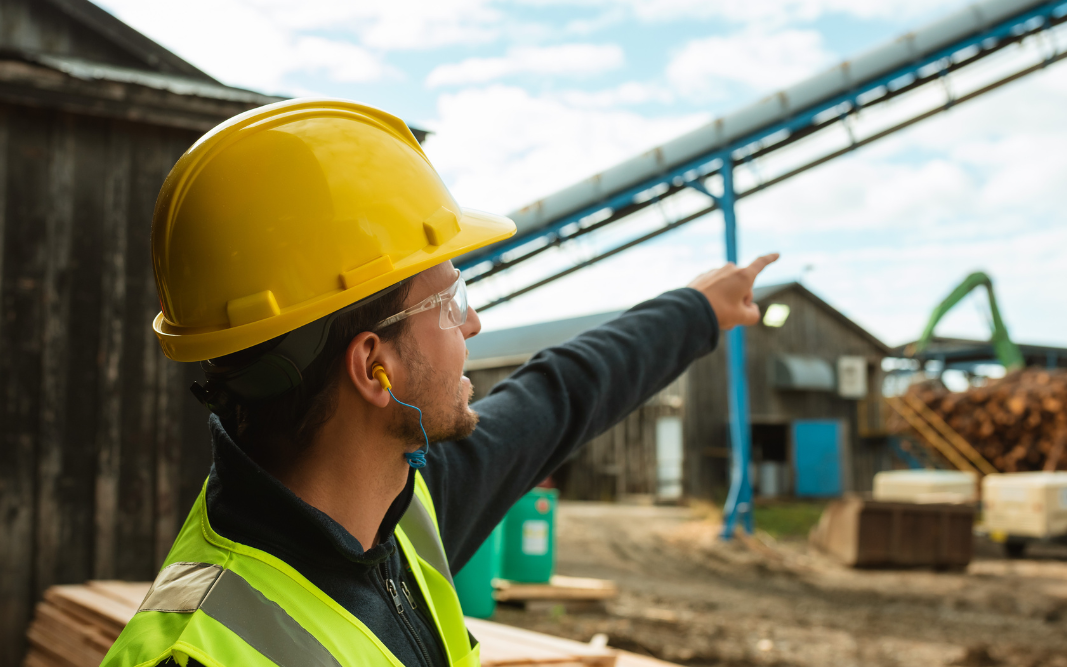 Man with hard hat pointing at Sawmill